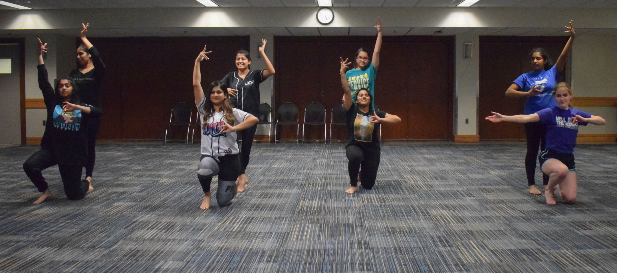 Eight dancers perform a Bollywood fusion dance routine